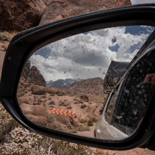 Close-up of 4Runner wide view side mirror reflecting a desert landscape