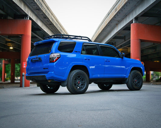 Voodoo Blue 5th gen Toyota 4Runner TRD Pro on all-terrain tires