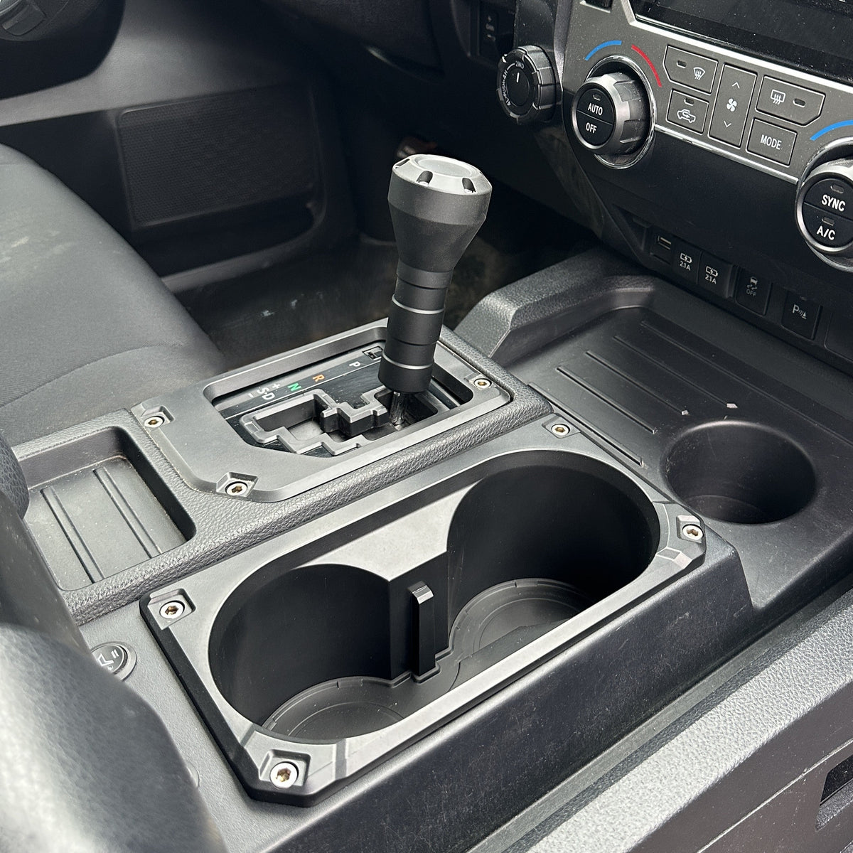 AJT Design v2 oversize cup holder + shifter/shift gate trim rings for a 2014-2021 Toyota Tundra.